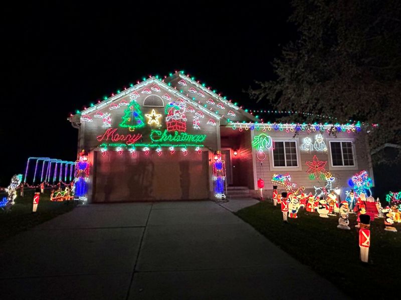 The front of the house with a Merry Christmas sign across the gable