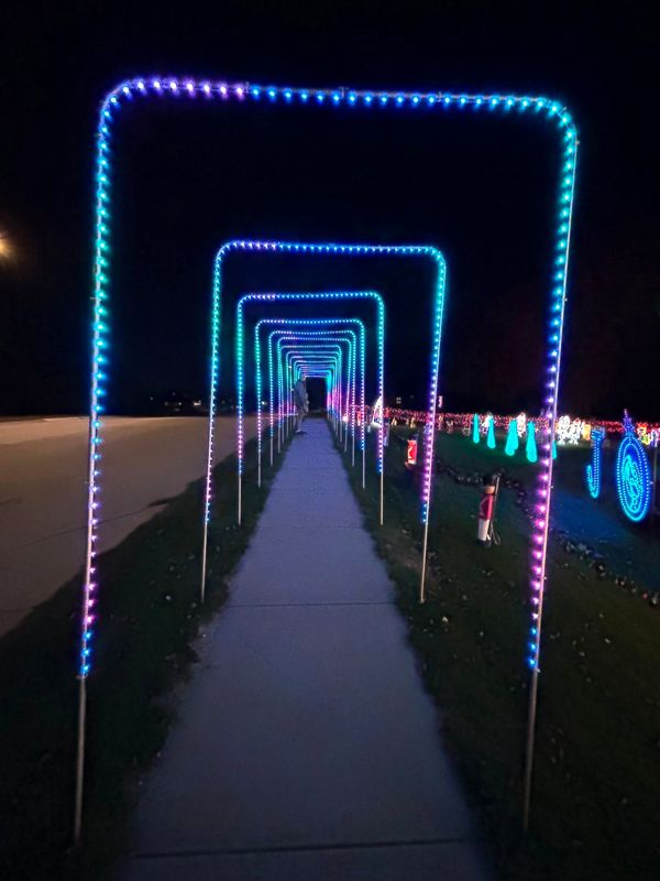 A tunnel of lit arches running the length of the front walk